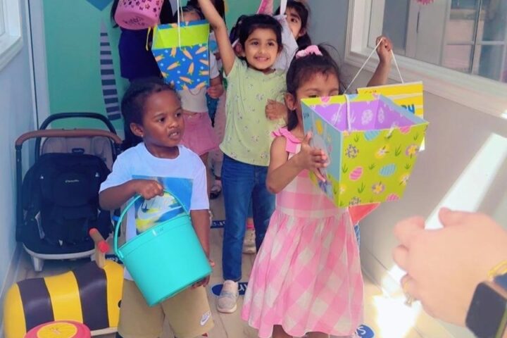 Children showing colorful arts and crafts projects