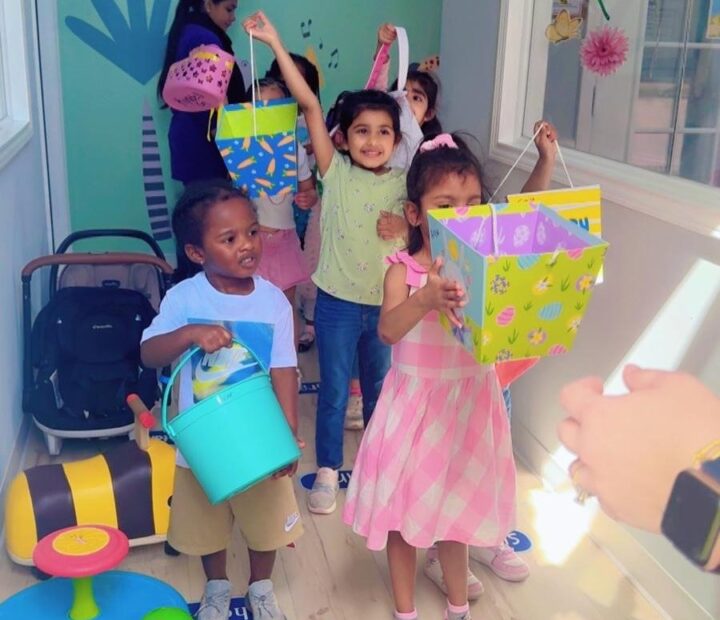 Children showing colorful arts and crafts projects