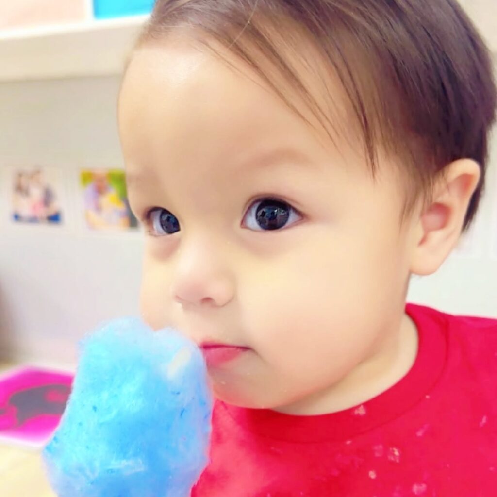 Infant participating in an age-appropriate sensory activity