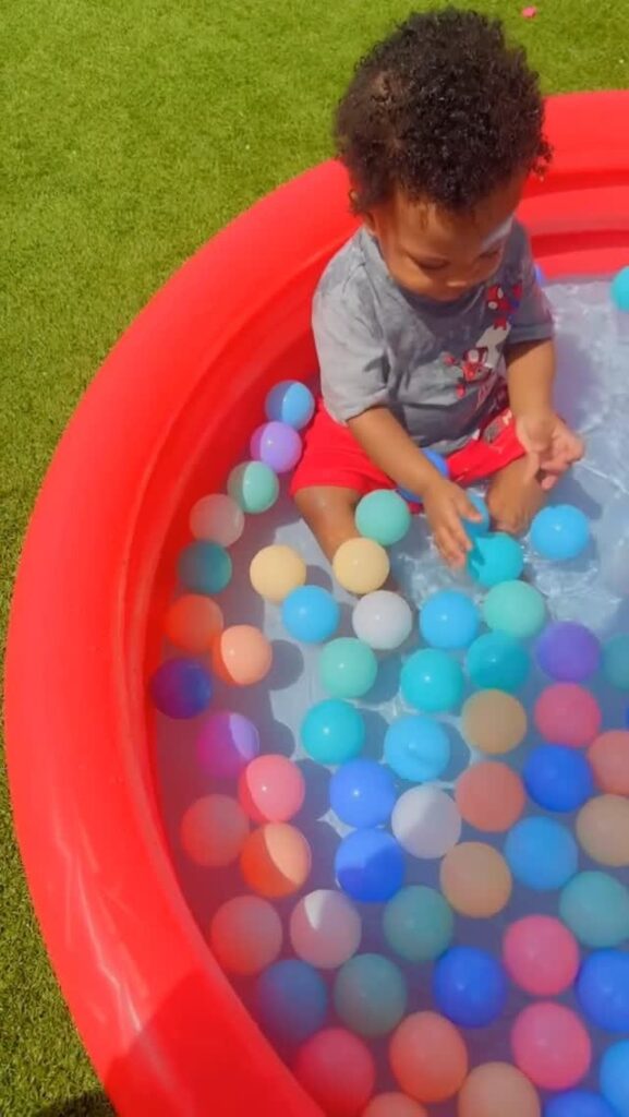Toddler enjoying a supervised colorful play activity