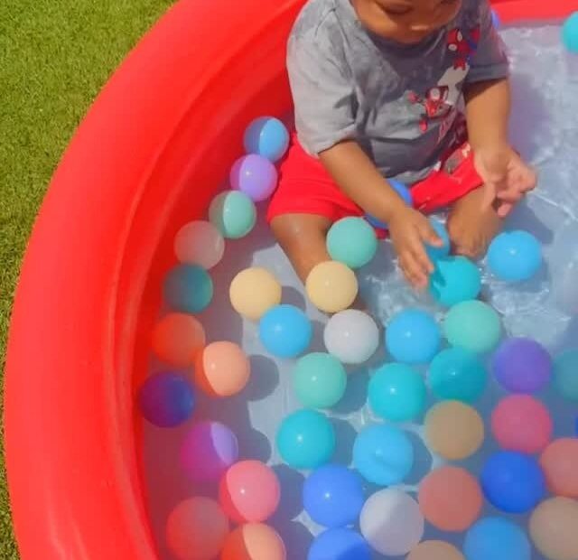Toddler enjoying a supervised colorful play activity